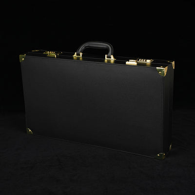 Black briefcase with gold accents on a black background