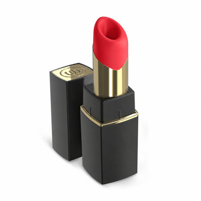 A red lipstick bullet vibrator in a black and gold tube, standing next to its matching black cap on a clean white background.