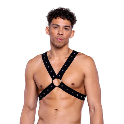 Man wearing a black strappy top and mesh underwear on a white background
