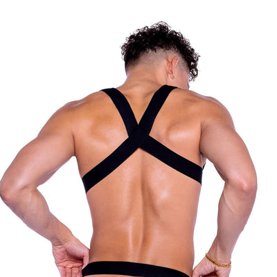 Person wearing a black strappy outfit on a white background