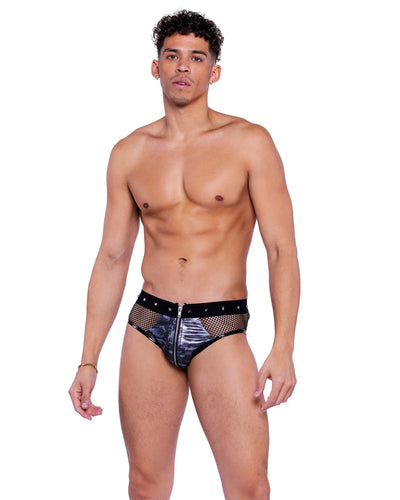 Man wearing metallic underwear with studded details on a white background