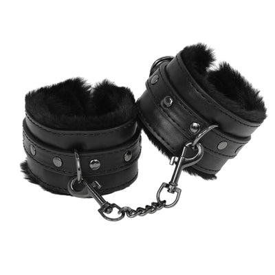 Black leather cuffs with fluffy interior on a white background