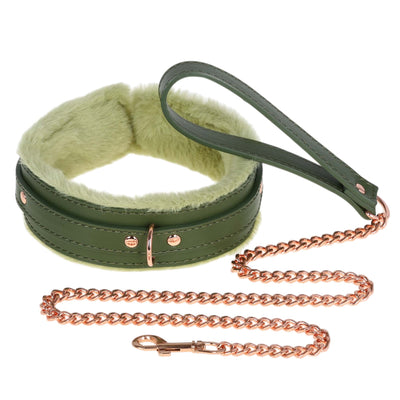 Green leather collar with fluffy interior and rose gold chain leash on a white background