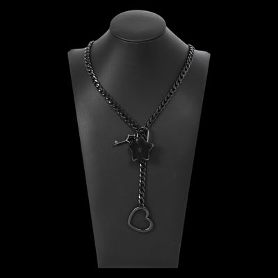 Black chain necklace with star and heart pendant on a black mannequin bust.