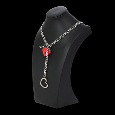 Necklace with heart-shaped pendants on a black stand against a white background
