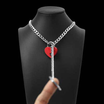 Silver chain necklace with a red heart pendant on a black mannequin bust.