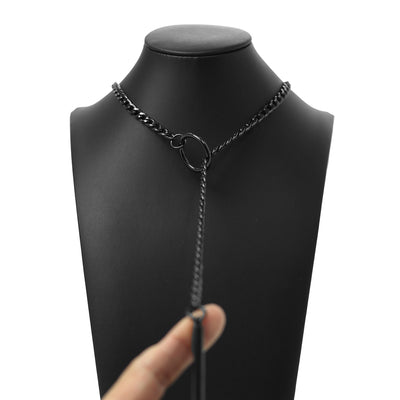 Black chain necklace on a mannequin with a hand holding it