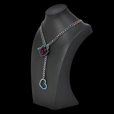 Necklace with heart-shaped pendant on a black mannequin bust against a black background