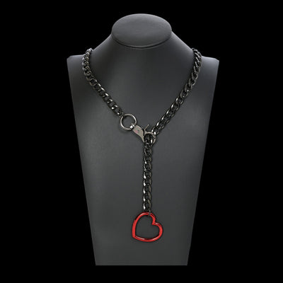 Black chain necklace with a red heart pendant on a mannequin bust.