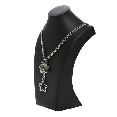 Silver chain necklace with star pendants on a black mannequin bust.