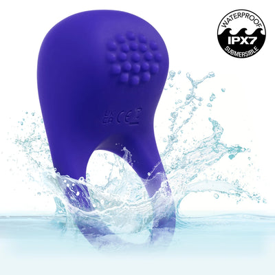 A purple silicone personal massager with a curved body and textured circular head, shown rising from water with a splash. A circular 'Waterproof IPX7 Submersible' badge is in the top right corner.