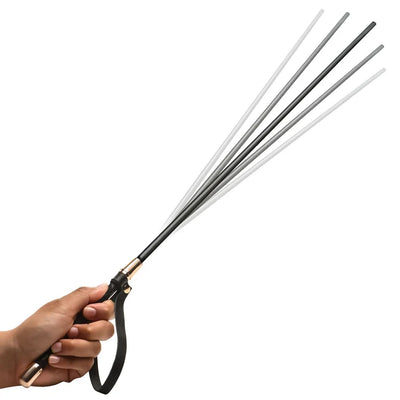 Hand holding a black riding crop on a white background