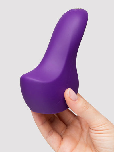 A purple silicone personal massager held in a person's hand against a light gray background.